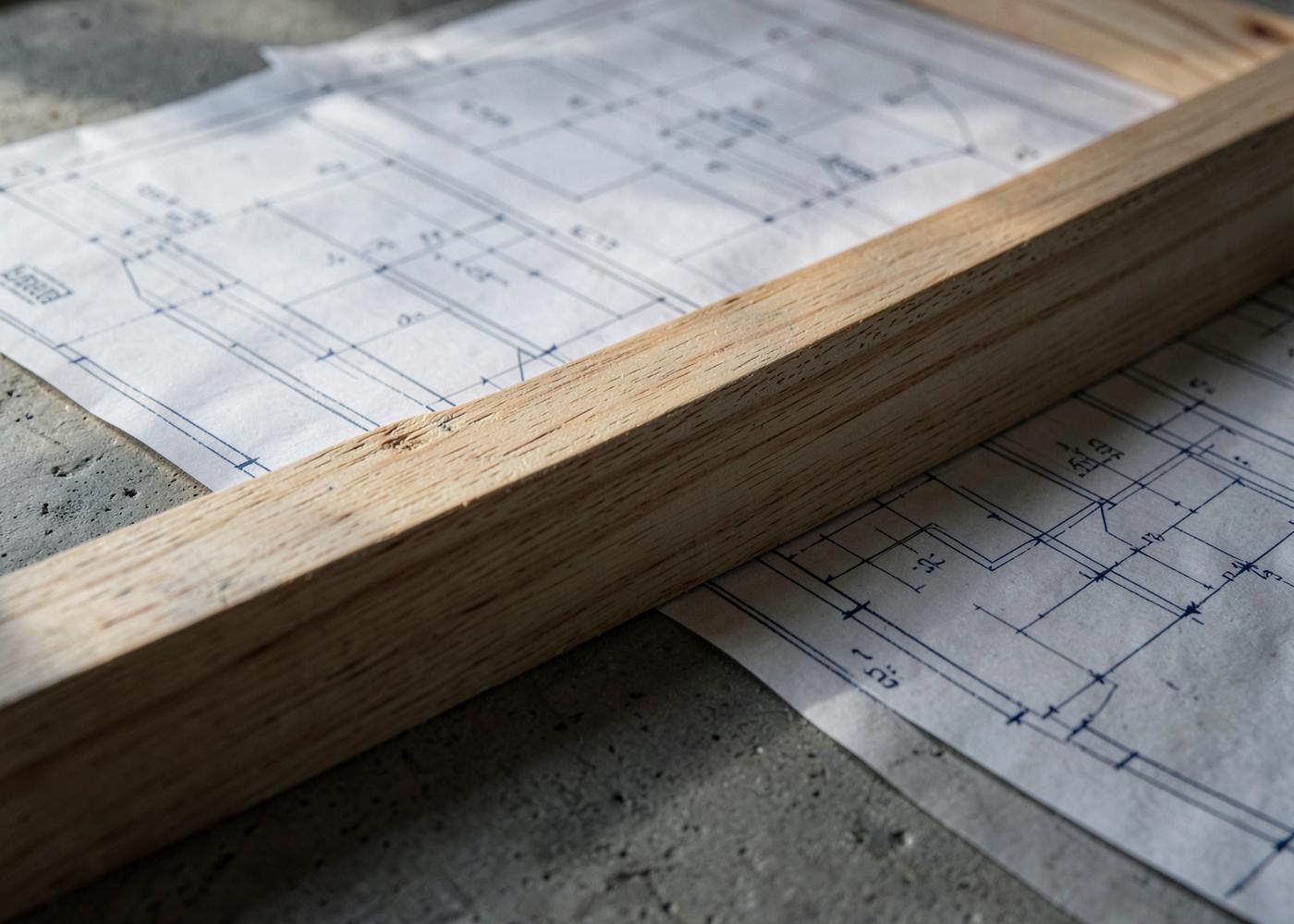 Construction drawings and framing lumber on concrete